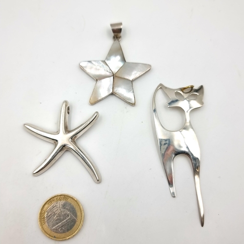 56 - A collection of three sterling silver pendants, comprising of a five point Mother of Pearl star, a S... 