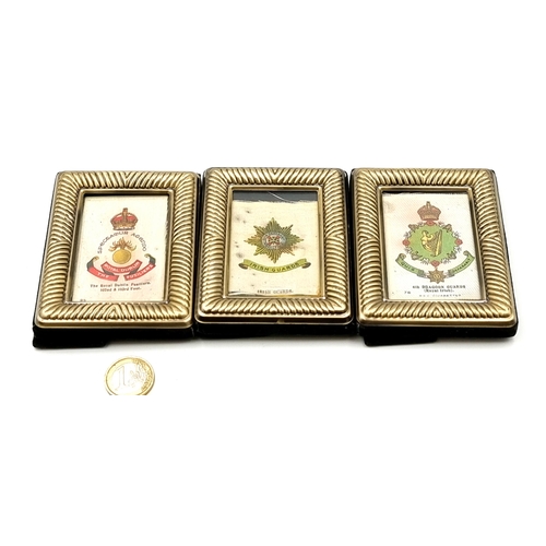 891 - A collection of three Irish military silks badges, each mounted and set in glazed photo frames. Cons... 