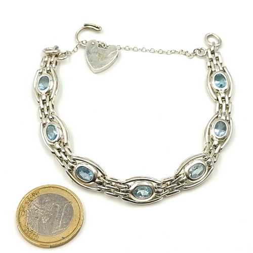 893 - A sterling silver Aquamarine stone bracelet, set with locket clasp and safety chain. Weight: 19 gram... 