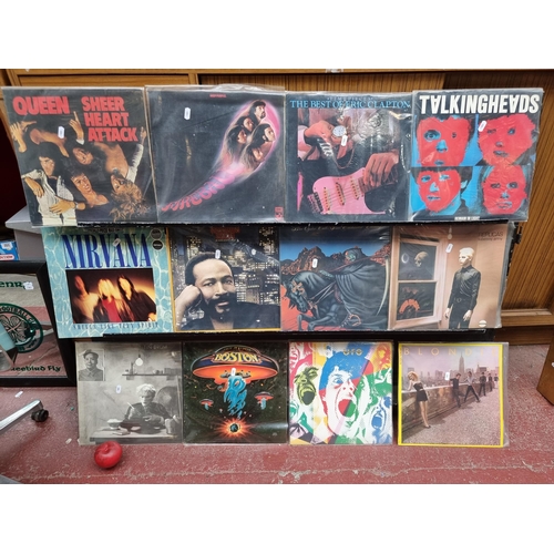 924 - 12 vintage vinyl records and albums by artists such as Queen, Deep Purple, Eric Clapton, Talking Hea... 