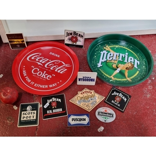 949 - Eleven breweriana items including branded trays for Perrier and Coca Cola. With other bar mounts etc... 