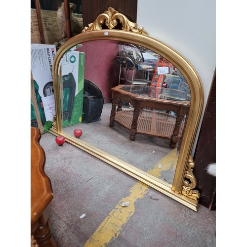 846 - A very large Regency style over mantle mirror with bevelled glass and a gilt frame with an acanthus ... 