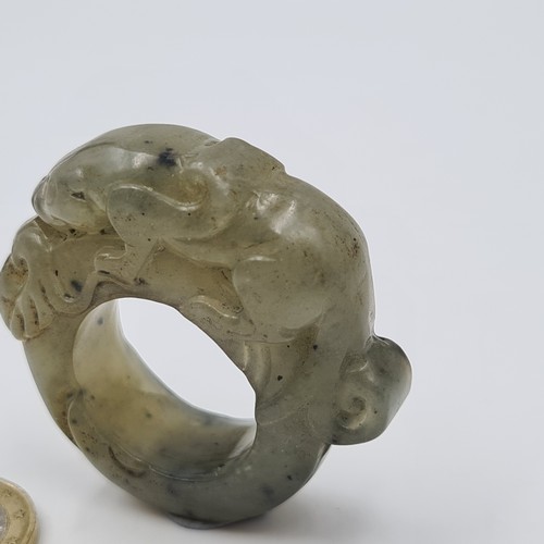 2 - A fine example of an antique natural green Jade Chinese ceremonial ring, featuring a hand carved cro... 