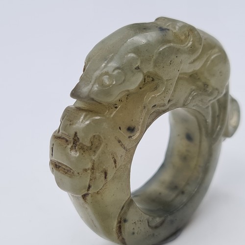 2 - A fine example of an antique natural green Jade Chinese ceremonial ring, featuring a hand carved cro... 