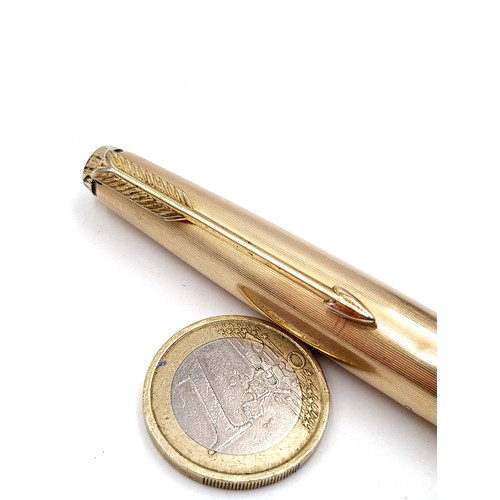 16 - A Parker 51 fountain pen, featuring a 12 carat rolled gold cap and a black bodied finish.