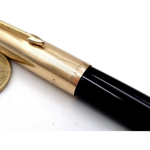 16 - A Parker 51 fountain pen, featuring a 12 carat rolled gold cap and a black bodied finish.