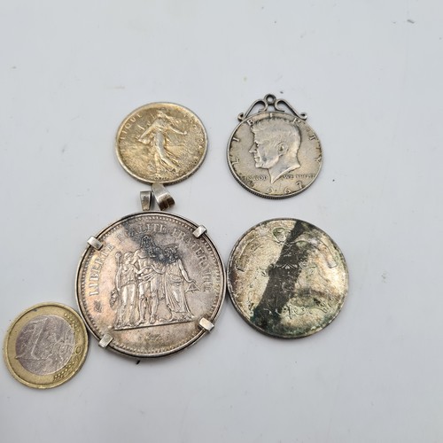 37 - A collection of three coin pendants, comprising of a 1977 50 Franc piece, a 1960 5 Franc, a 1967 Ken... 