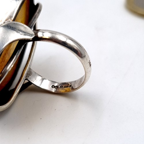 57 - A large and generous Baltic Amber ring, set in sterling silver. Ring size: P. Weight: 12.64 grams.