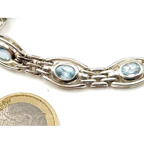 893 - A sterling silver Aquamarine stone bracelet, set with locket clasp and safety chain. Weight: 19 gram... 