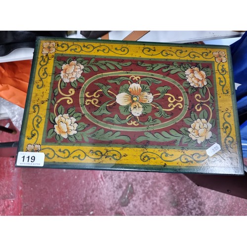 119 - A charming handpainted tabletop cupboard with handpainted front doors featuring floral motifs and ma... 
