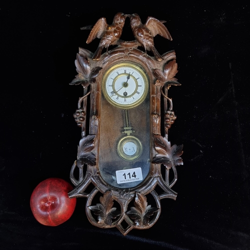 114 - A beautiful hand carved pendulum wall clock with wonderful floral detail throughout and two song bir... 