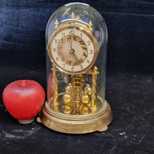 124 - A vintage German made dome clock with the 12 signs of the zodiac depicted to the clock face. Intact ... 