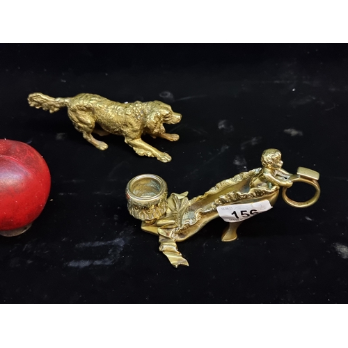 156 - Two solid brass items including a chamber candle holder in the form of a ladies' heeled slipper and ... 