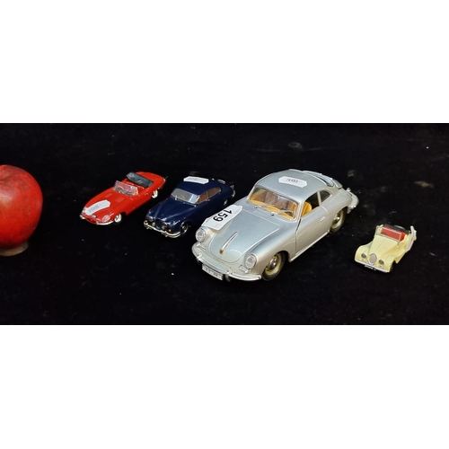 159 - Four model cars including a Burago Porsche (1:24) and a Vanguards Lledo Jaguar E-Type.