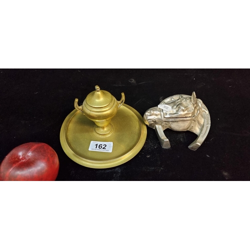 162 - A solid brass inkwell set featuring a double handled urn to centre and removable glass liner. Along ... 