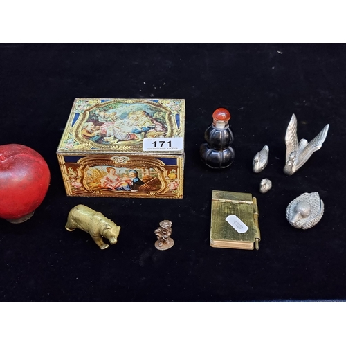 171 - A charming Kemps chocolate finger tin containing eight small collectables. Including a vintage minia... 