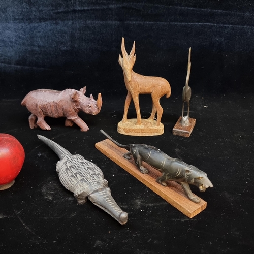 187 - A selection of five carved African figures including a beautiful carved horn Jaguar and a heron alon... 