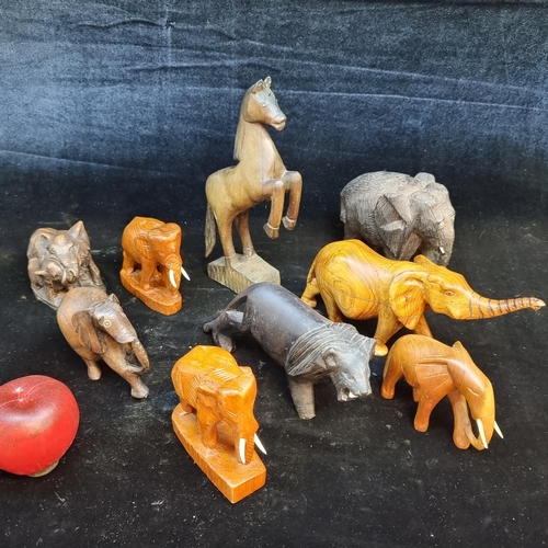 197 - A selection of nine carved wooden animal figures. Including a ebony elephant and multiple carved tea... 