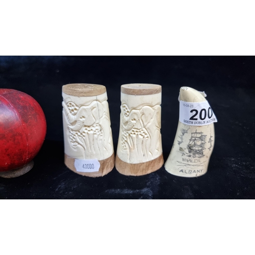 200 - A pair of carved bone salt and pepper shakers . Along with a neat sized horn style carved tooth, mar... 