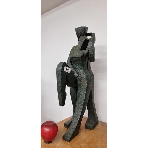 216 - A very heavy large abstract sculpture of a couple titled 'Friendship Loving Touch' and marked 'CWSL ... 