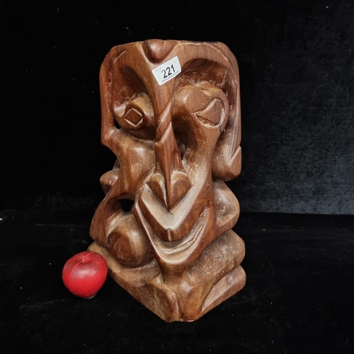 221 - An abstract handcarved wooden sculpture by Guyanese Marvin Phillips depicting a face and dating to 2... 