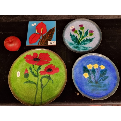 237 - Four ornate items including three beautiful enamelled over copper plates by Jim Millar featuring flo... 