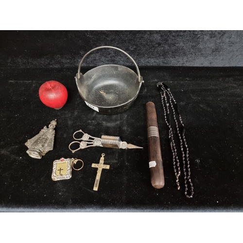 242 - A cast metal small cauldron with hanging handle , a candle wick snuffer a black wooden kosh and a se... 