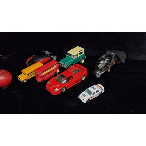 244 - Seven model vehicles including a diecast Ferrari from Burago and a school bus. Along with a Batman f... 