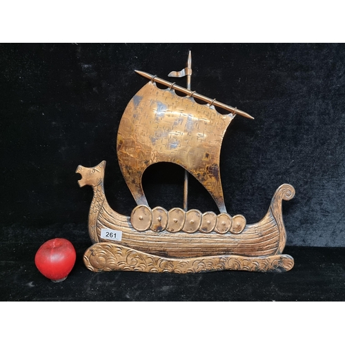 261 - An ornate copper wall hanging of a Viking ship with an expanding sail.