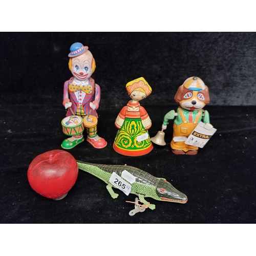 265 - Four vintage diecast articulated figures including a windup alligator, a windup clown, a Russian dan... 