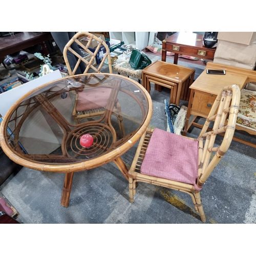 938 - A three part wicker and bamboo dining suite comprising of a round table with a tinted glass top (H73... 