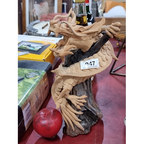 947 - A very cool  sculpture depicting a traditional Chinese dragon wrapped around an organic wooden stem.