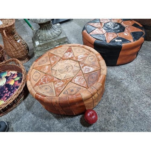 959 - Two Moroccan leather foot stool / floor cushions. Both designed with contrasting geometric cuts of l... 