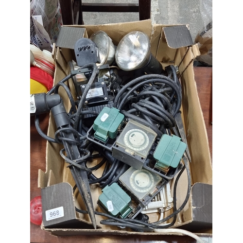 968 - A large mixed box of seven garden items. Including garden lighting with stake ends and two sprinkler... 