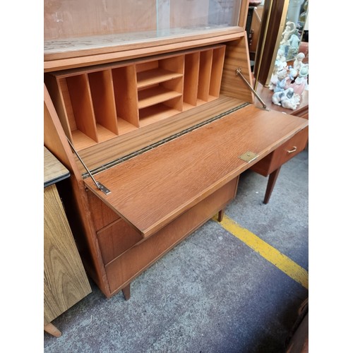 984 - Star Lot : A fabulous vintage Mid Century teak dresser with three full length drawers to base, a fol... 