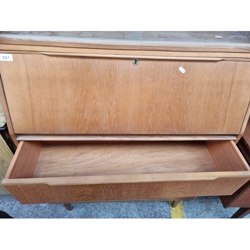 984 - Star Lot : A fabulous vintage Mid Century teak dresser with three full length drawers to base, a fol... 