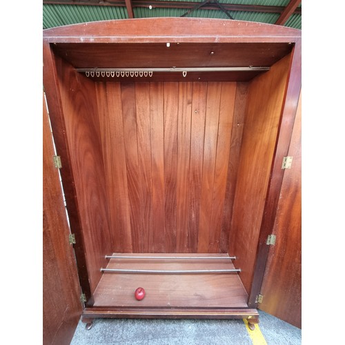 986 - Star Lot : A vintage handsome double wardrobe with flamed mahogany front. Featuring integrated shoe ... 