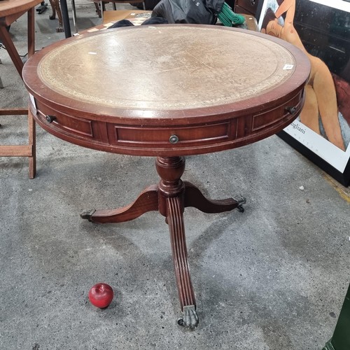 987 - Star Lot : A very elegant large vintage drum table with a round top finished with tooled leather. Fi... 