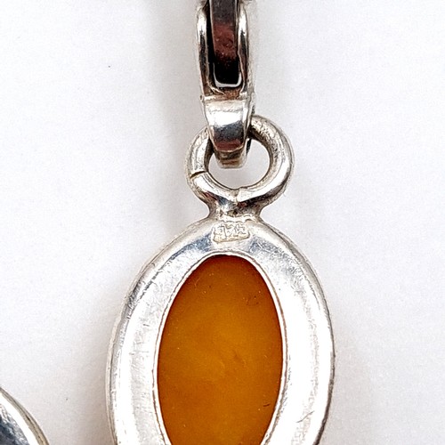 33 - A fine example of a sterling silver bracelet, featuring eight natural Butterscotch Amber stone setti... 