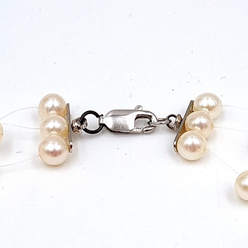 32 - Two very attractive sterling silver set Fresh Water Pearl necklaces, the first is a floating style t... 