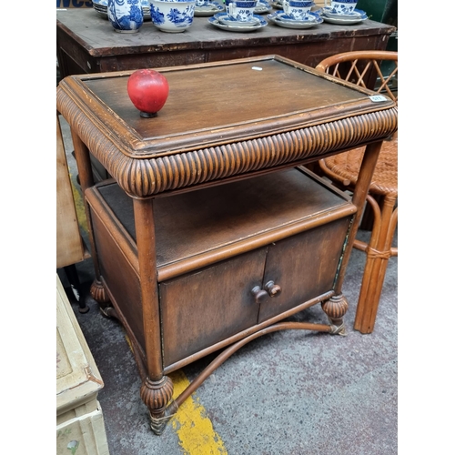 571 - A vintage side table with bentwood detail. Featuring cupboard to base and gadrooned edge. H74cm x W6... 