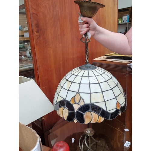 577 - A large Tiffany style ceiling lamp shade. Designed in shades of cream, caramel and amber. D40cm