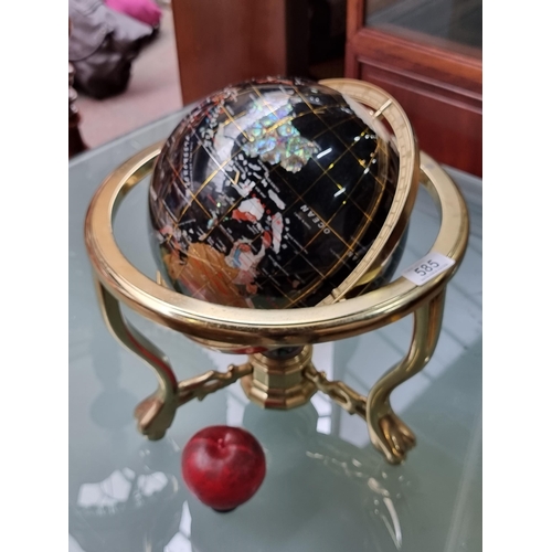 585 - A heavy spinning Lapiz world globe with gemstone inlay and compass to base. Suspended on a gimbal me... 