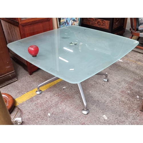 586 - A contemporary frosted glass coffee table with chrome legs. Some wear to surface. H45cm x D83cm