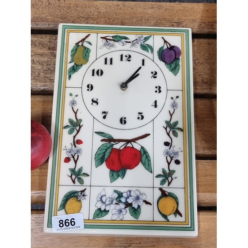 866 - An unusual heavy pretty porcelain battery operated wall clock with hand painted fruit and floral det... 