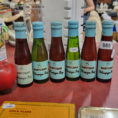 885 - A fabulous collection of six vintage sealed bottles of Babycham Champagne Perry.