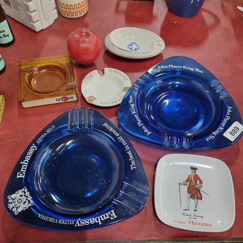 889 - A selection of six vintage ashtrays including two large blue glass examples for John Player and Emba... 