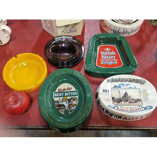 891 - A lot of five vintage pub ashtrays including a glass Benson and Hedges example.