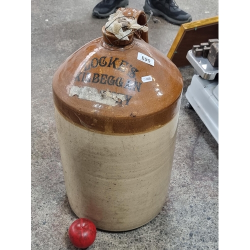 899 - Star Lot : A very large and heavy vintage stoneware flagon with original cork intact. Reads 