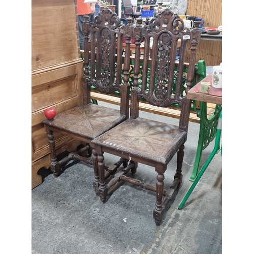 922 - A beautiful pair of antique Arts and Crafts hall chairs with ornate floral carving to back panels an... 